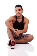 Image showing young and handsome latin man, seated on floor