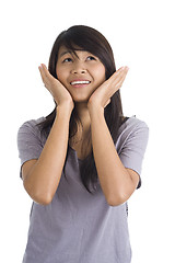 Image showing scared young woman looking up