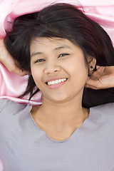 Image showing beautiful woman on pink silk