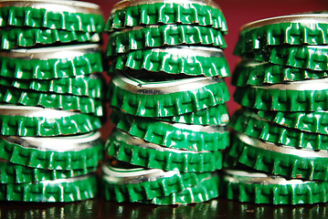 Image showing pile of green beer caps
