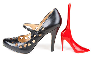 Image showing Black feminine loafer and red shoehorn