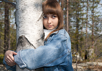 Image showing Young beautiful girl and birch