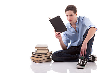 Image showing cute boy reading a book on the floor