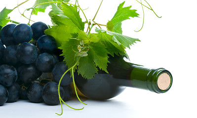 Image showing bottle of red wine with grapeleaf and grape