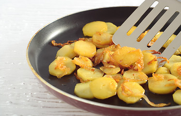 Image showing Fried potatoes' slices on frying pan