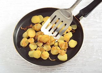 Image showing Fried potatoes' slices on frying pan