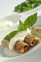 Image showing Rolled pore's leaves with cream (creme fraiche) and basil 