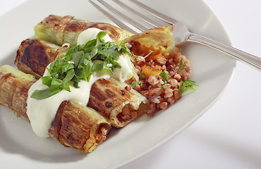 Image showing Rolled pore's leaves with cream (creme fraiche) and basil