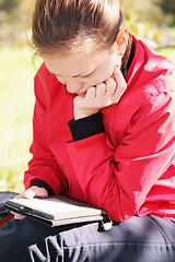 Image showing Woman reading electronic book