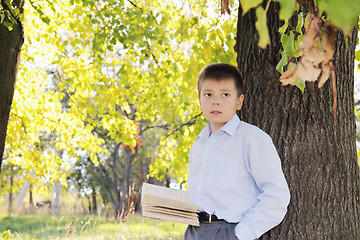 Image showing Boy with book looking sideways