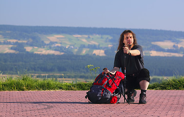 Image showing Crouching tourist