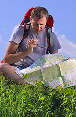 Image showing Tourist looking on map