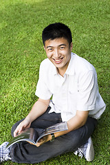 Image showing young student reading books at the school park