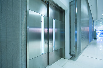 Image showing  big steel door in office building with long corridor 