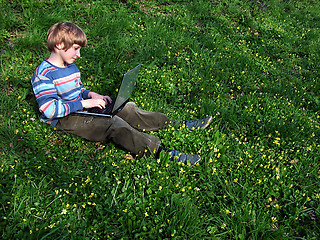Image showing child with notebook sit green grass