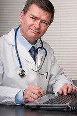 Image showing Friendly doctor smiles at camera