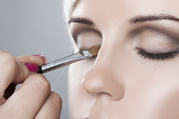 Image showing Woman having her makeup applied