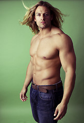 Image showing athletic sexy male body builder with the blonde long hair