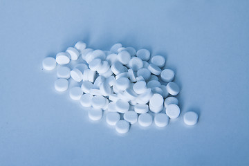 Image showing white pills on blue background