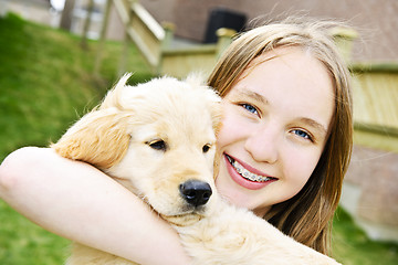 Image showing Girl with puppy