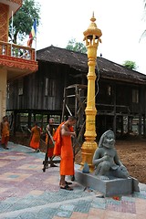 Image showing Monks fixing a lamp