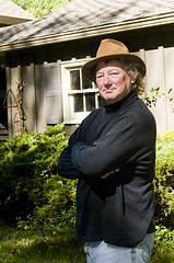 Image showing middle age senior man with fashionable hat in yard