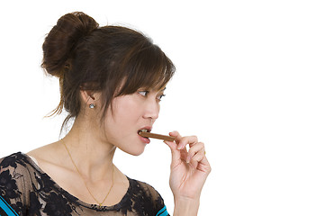 Image showing beautiful woman eating chocolate