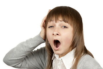 Image showing Young beautiful girl yawns