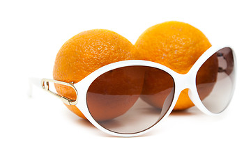 Image showing Sunglasses and two oranges