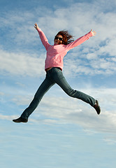 Image showing Girl in jump on background sky