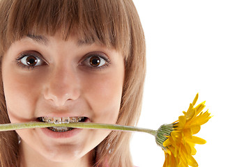 Image showing Portrait of the girl with yellow gerbera in teeth