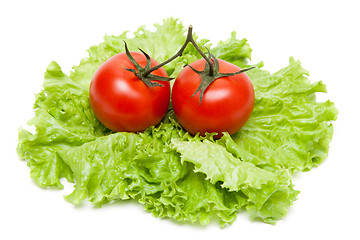 Image showing Two ripe tomatoes on sheet of the salad