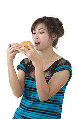 Image showing young woman eating a hamburger