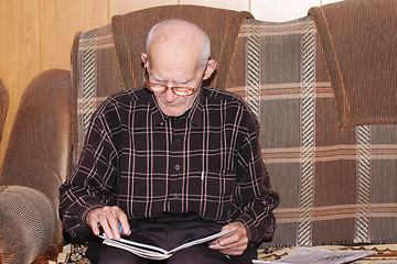 Image showing Serious senior man working at home