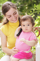 Image showing Baby girl with phone receiver