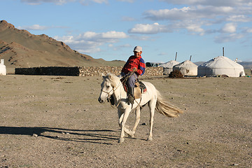 Image showing Mongolian boy racing on a horse