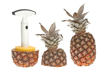 Image showing Whole and split pineapple with cutter