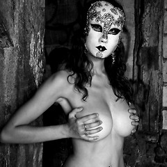 Image showing Masked woman who hides her breasts