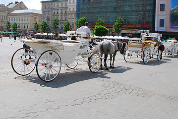 Image showing Horse-drawn buggies trot around Krakow 