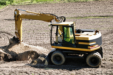 Image showing Photo of a working excavator in the countryside 