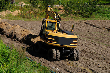 Image showing Photo of a working excavator in the countryside 