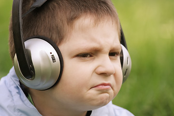 Image showing Portrait of sceptic boy in headphones