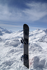 Image showing Snowboard against the hight mountains