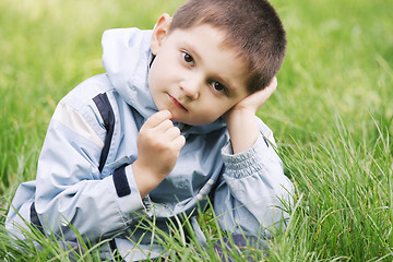 Image showing Thoughtoful little boy in grass