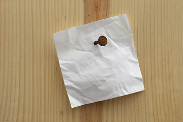 Image showing blank reminder note nailed to a wall