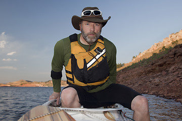 Image showing paddler boarding his canoe