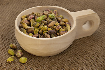 Image showing scoop of raw shelled pistachio nuts