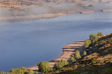 Image showing foggy morning on mountain lake