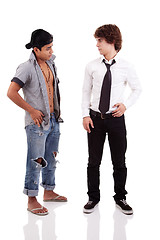 Image showing two men of different ethnicity, one looking at the other standing