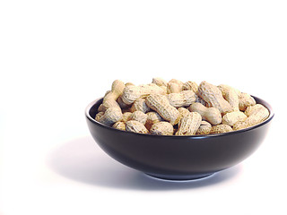 Image showing Black bowl with unshelled peanuts